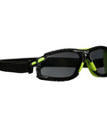 Badass Anti Fog Coating Keeps Your Safety Gear Sleek And Clear Through Twenty Five Water Washes While Providing Bulletproof Scratch Shield For Any Hard Hat Hustle, featuring lightweight black and green safety glasses with a strap.