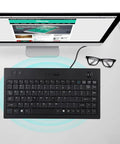 Heavy Duty Wired USB Keyboard With Eighty Eight Keys Dead Silent Business Keypad For Quick Data Entry Or Chill Gaming Sessions Bulletproof Design Plug And Play Ready, top view with monitor and glasses.