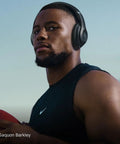 Person wearing Studio Pro Premium Wireless Over Ear Headphones With Up To 40 Hour Battery Life And Active Noise Cancellation.