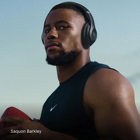 Person wearing Studio Pro Premium Wireless Over Ear Headphones With Up To 40 Hour Battery Life And Active Noise Cancellation.
