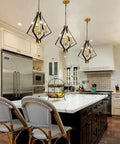 Modern kitchen with 4 Light Lantern Chandelier In Black And Gold With A Dope Mid Century Geometric Square Cage Pendant Light above island
