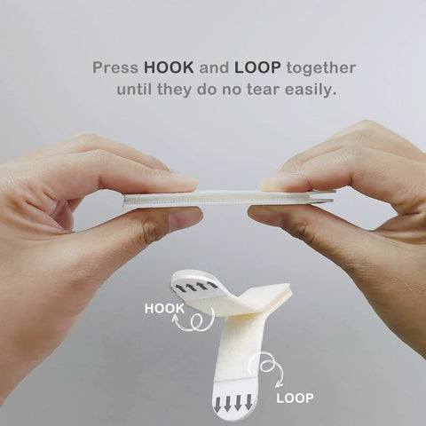 Demonstrating use of Heavy Duty Picture Hanging Strips 24 Pairs 48 Strips Removable Hook And Loop Mounting Tape with hands.