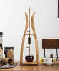 Heavy Duty Cold Brew Coffee Maker With Sleek Ice Drip Tower For Bold Tea And Coffee, 500ml Double Layer Glass Cold Brew Drip Tower pulling chilled extracts on a wooden table.