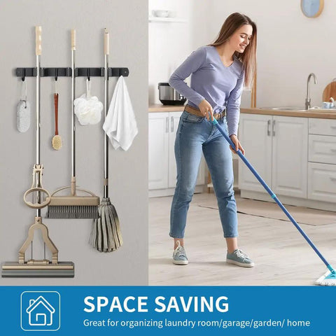 Built Tough Heavy Duty Wall Mounted Broom And Mop Holder, Stainless Steel Tool Organizer Rack With 3 Racks And 4 Hooks, Matte Black, shown mounted in a kitchen.