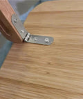 Close-up of Built Tough 180 Degree Foldable Hinge Set for Furniture and Marine Cabins, metal silver finish on wooden surface.