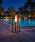 Rustic Solar Lantern For Outdoor Use With Portable Handle by poolside at night, 22-inch tall waterproof all-weather steel yard light.