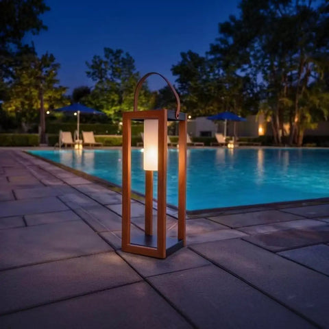Rustic Solar Lantern For Outdoor Use With Portable Handle by poolside at night, 22-inch tall waterproof all-weather steel yard light.