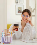 Smiling person at desk with Rotating Pencil And Pen Holder With Five Slots, Space Saving Desk Organizer for School, Home And Office.