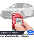 Hand holds Jeep Wrangler Red TPU Flip Key Fob Cover For JL JLU Rubicon Wagoneer Gladiator JT Sahara with car in background.