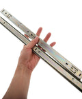 Hand holding Heavy Duty 27mm Wide Full Extension Ball Bearing Drawer Slides for Keyboard Tray and Nightstand Cabinets.