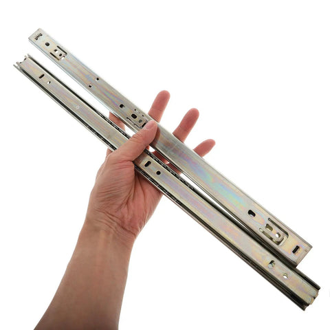 Hand holding Heavy Duty 27mm Wide Full Extension Ball Bearing Drawer Slides for Keyboard Tray and Nightstand Cabinets.