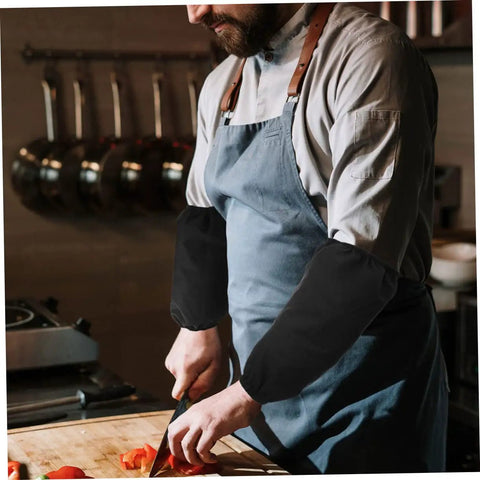 Six Pairs Oil Resistant Arm Sleeves Long Kitchen Cooking Oversleeves With Grippy Elastic Bands Keeping Your Clothes Clean During The Daily Hustle Straight Up Heavy Duty Material That Repels Oil Like A Pro, worn by a chef in a kitchen chopping vegetables.