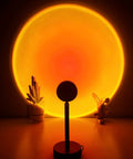 Sunset Projection Lamp With 180 Degree Rotation LED Night Light For Photography And Selfies casting a warm sunset glow.