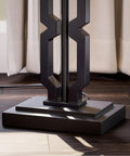 Base detail of the Tall Black Floor Lamp With White Rectangular Shade, 59.5 Inch Height, plastic construction shown on wood floor