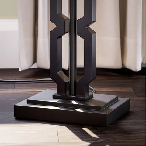 Base detail of the Tall Black Floor Lamp With White Rectangular Shade, 59.5 Inch Height, plastic construction shown on wood floor