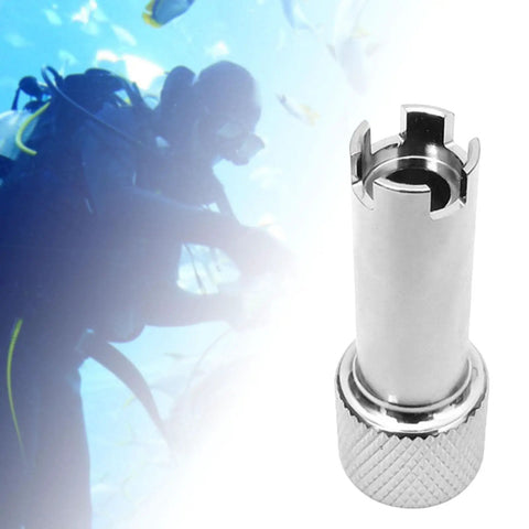 Second Stage Regulator Adjustment Tool For Scuba Diving With Four Slots Inline Drive, chrome plated copper, beside diver.