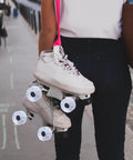 Person holding quad skates with Light Up Roller Skate Wheel Set For Outdoor Indoor Inline Skates And Quad Skates Replacement PU Wheel