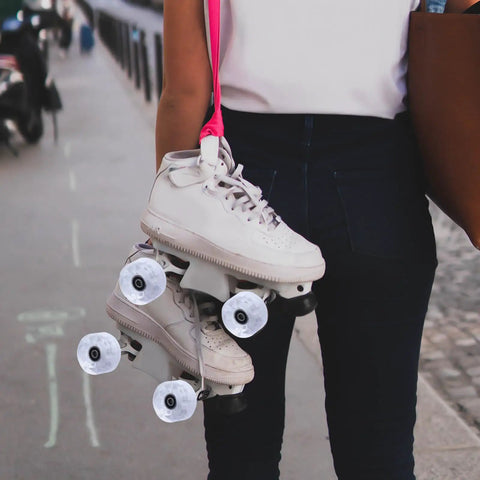 Person holding quad skates with Light Up Roller Skate Wheel Set For Outdoor Indoor Inline Skates And Quad Skates Replacement PU Wheel