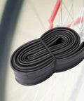 Coiled black butyl rubber 12 inch bike inner tube with AV32mm Schrader valve, 12 Inch Bike Inner Tubes For 12x1.75 12x1.90 12x1.95 12x2.0 12x2.10 12x2.125 With AV32mm Schrader Valve 2 Pack Fits Road Mountain And Kid Bikes Durable Butyl Tubes.