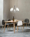 Traditional 5 Light Chandelier In Brushed Nickel With Clear Glass Shades over modern dining table with gray chairs