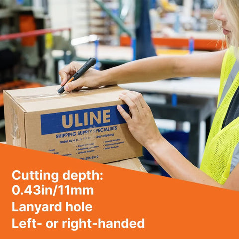 Slice 10513 pen cutter with black handle cutting a cardboard box in a warehouse; manual blade