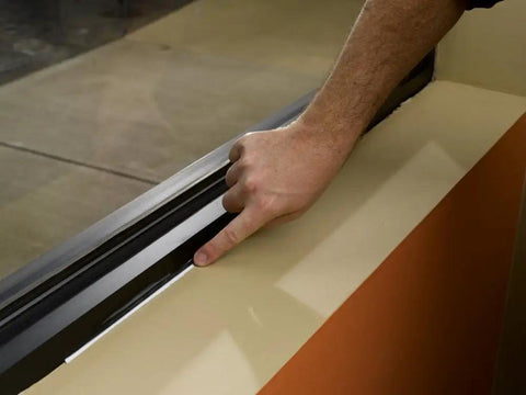 Applying Big Stretch Caulk 10.5 Oz White Heavy Duty Flexible Acrylic Latex Sealant to window frame interior and exterior use.