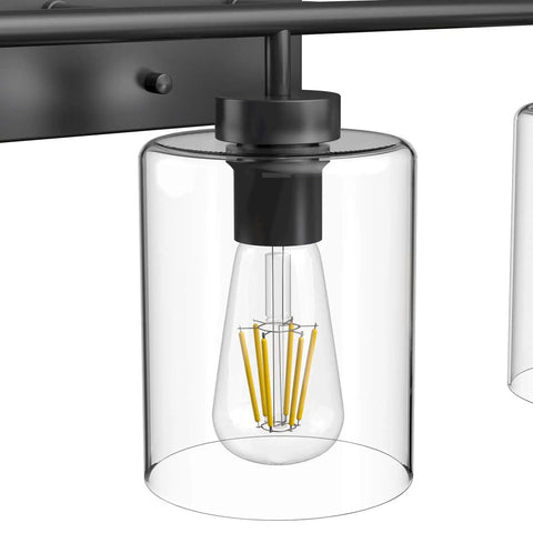 Close-up of Three Light Black Vanity Light Fixture Over Mirror With Clear Glass Shades Industrial Wall Light For Bathroom Upgrade Modern Vintage Look Matte Black Frame