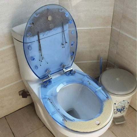 Hella Durable Round Resin Toilet Seat With Crystal Clear Aquarium Vibe And Smooth Sit Ergonomic Comfort Featuring Rock Solid Metal Hinges For A Top Tier Bathroom Setup That Looks Absolutely Sick, showing transparent seat with smooth blue finish.
