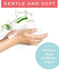 Hands using XL Shower Wipes For Adults No Rinse Bathing On The Go Clean Up Wipes, splash of water in background.