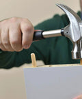 Person using a hammer to insert 1000 Piece Five Sixteenth Inch Wooden Dowel Pins Set For Woodworking, into a board.