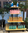 Straight Up Sturdy Four Tier Square Storage Rack Multi Purpose Steel Shelving Unit For Kitchen Warehouse Grocery Display holding various hair products.