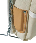 Close-up of beige Canvas And Leather 5 Pocket Tool Pouch With Chain Tape Thong And Tunnel Belt Connection for Pros and DIYers.