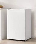 White 3.0 Cu Ft Upright Freezer With 7 Adjustable Temp Settings Compact Mini Freezer in kitchen corner for space saving.