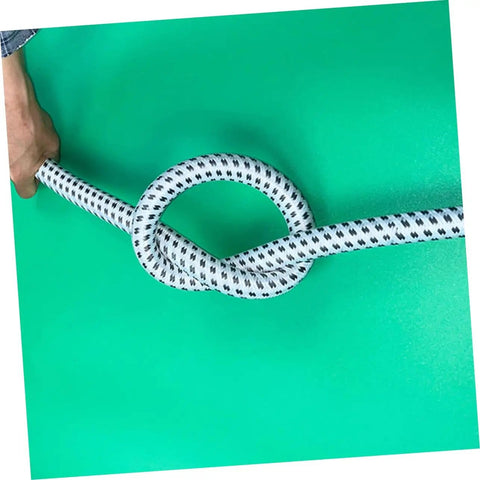 Hand holding flexible PVC and nylon tube, high temperature steamer hose replacement for all steam irons, shown knotted to show flexibility.