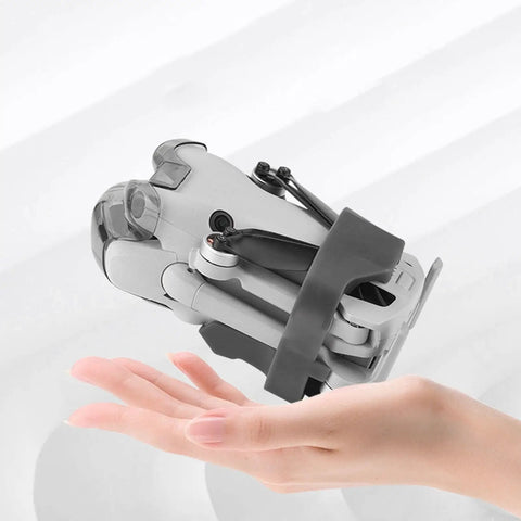 Rock Solid TPU Drone Propeller Strap Quick Install Secure Fastener And Travel Keeper For Mini 4 Pro securing drone in hand.
