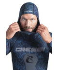 Model wearing 2mm Hooded Wetsuit 2-Piece Nylon Camouflage Blue For Spearfishing And Freediving, showing hood and logo, Size 2XL