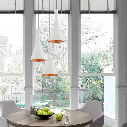 White 7.25-Inch Mini Pendant Light With Gold-Interior Metal Shade above dining nook table, adjustable cords visible