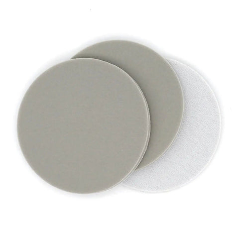 Six Pack 5 Inch Sponge Sanding Discs With Peel And Switch Backing For Easy Swap and Dust Vent Holes To Keep Your Workspace Clean While Polishing Or Grinding Wood Metal Or Plastic At Any Grit Level, showing three grey and white discs.