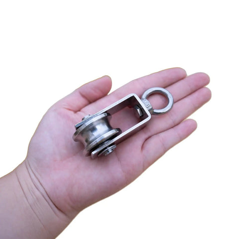 Beefy Stainless Steel Cable Pulley Block With Silent Bearings Swivel Kit For Heavy Duty Applications 550lb Load Capacity For Garage Attic Kayak Deer Hanging Gym Equipment 4 Pack, shown in hand
