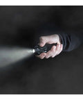 Person holding Blue Pocket Light That Fits In Your Hand And In Your Pocket, Built To Last For Go To Everyday Carry, emitting beam in dark