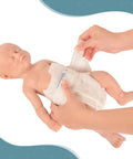 Legit Carefully Sculpted Full Silicone Reborn Boy Doll, Super Soft Sleepy Infant Figure With Flexible Joints being diapered.