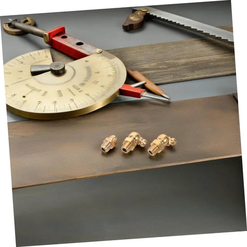 Close-up of 9 Piece Copper Grease Fitting Kit For Cars And Trailers, Pro Grade Nozzles And Oil Caps on a wooden surface.
