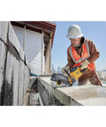 Worker using Flexvolt 9 Inch Diamond Cutting Wheel For Masonry And Concrete With Seven Eighths Inch Arbor 6600 Max RPM on concrete wall.