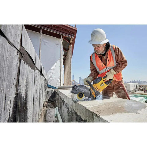 Worker using Flexvolt 9 Inch Diamond Cutting Wheel For Masonry And Concrete With Seven Eighths Inch Arbor 6600 Max RPM on concrete wall.
