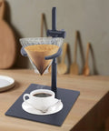 Level Up Your Morning Pour Over Coffee Dripper Stand With Height Adjustable Aluminum Stand Rock Solid Silicone Grip Lightweight Brew Holder Smooth Home Cafe Setup, with a glass dripper and steaming coffee cup.