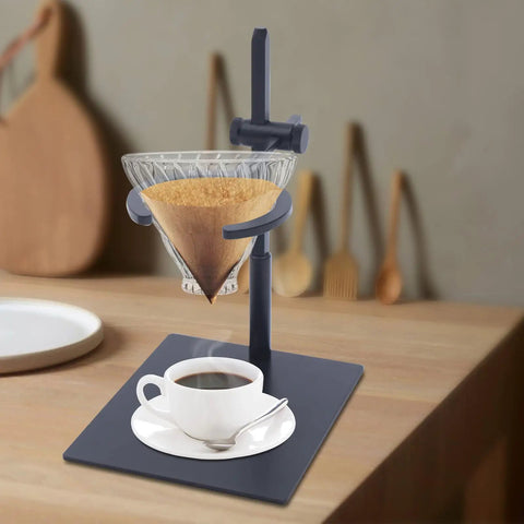 Level Up Your Morning Pour Over Coffee Dripper Stand With Height Adjustable Aluminum Stand Rock Solid Silicone Grip Lightweight Brew Holder Smooth Home Cafe Setup, with a glass dripper and steaming coffee cup.