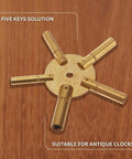 5 Prong Brass Clock Key For Winding Clocks With Odd Numbers Handy Universal Key Set shown on wooden background.