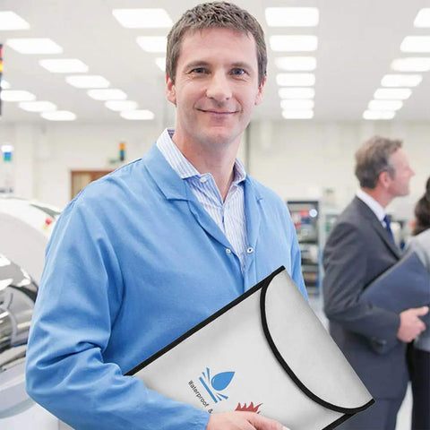 Man holding Heavy Duty Fireproof Document Bag For Cash And Files, Waterproof 15x11 Safe Storage Pouch with silicone coating in office