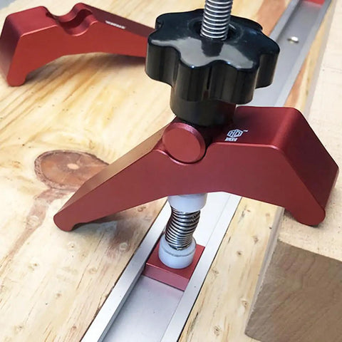 Rock Solid Aluminum T Track Hold Down Clamps For Woodworking And Metalworking Projects Plus Quick Slide In T Slot Press Clamps securing wooden workpieces.