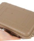 Hand holding Rugged Outdoor Survival Storage Box Shockproof Case For Camping, Hiking, Fishing And Field Use in mud color